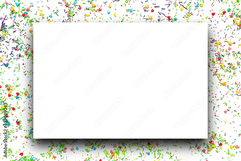 Isolated white frame on the background of multi-colored sweet sprinkles of different shapes in the form of hearts, stars, moon, flowers, round balls and sticks. Isolated white frame on the background of multi-colored sweet sprinkles of different shapes in the form of hearts, stars, moon, flowers, round balls and sticks.