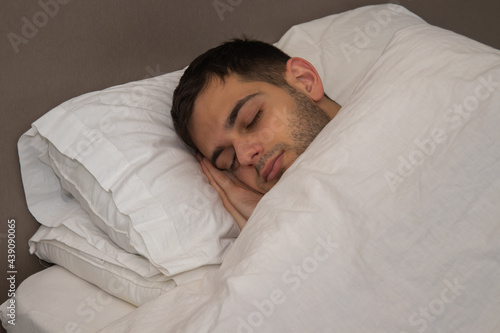 portrait young man sleeping in bed