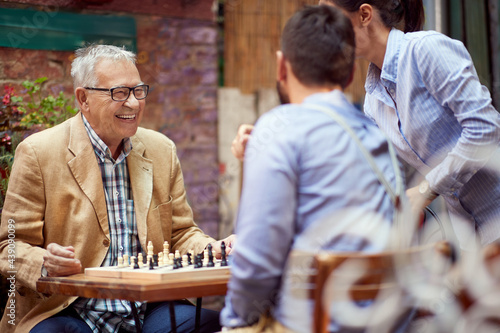 Принти на полотні older caucasian male smiling, happy to win in chess game