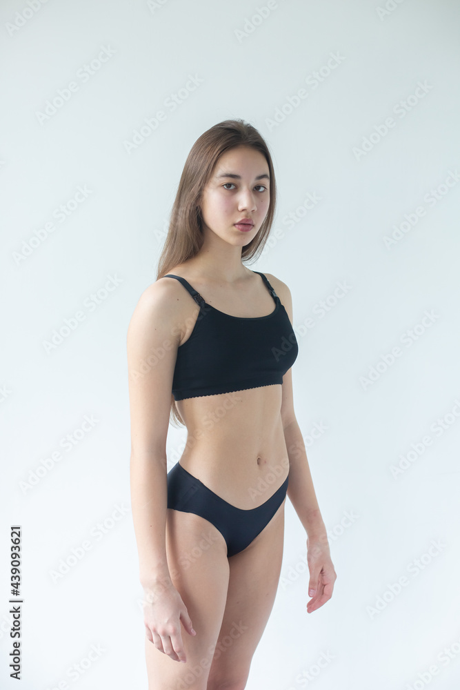 Natural beauty brunette model no make up in swimsuit posing in studio on isolated background. Model tests, natural no make up models concept Natural beauty brunette model no make up in swimsuit posing in studio on isolated background. Model tests, natural no make up models concept