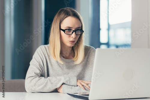 young business woman freelancer working online by conference or video call via laptop webcam at home. Confident Female teacher talks to students or colleagues. Businesswoman Conversation at distance 