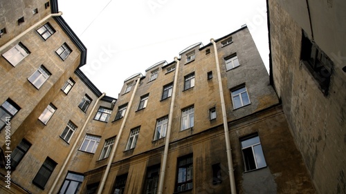 St. Petersburg, Russia. Residential building with many apartments. City street. Facade of an apartment building. Well yard. 