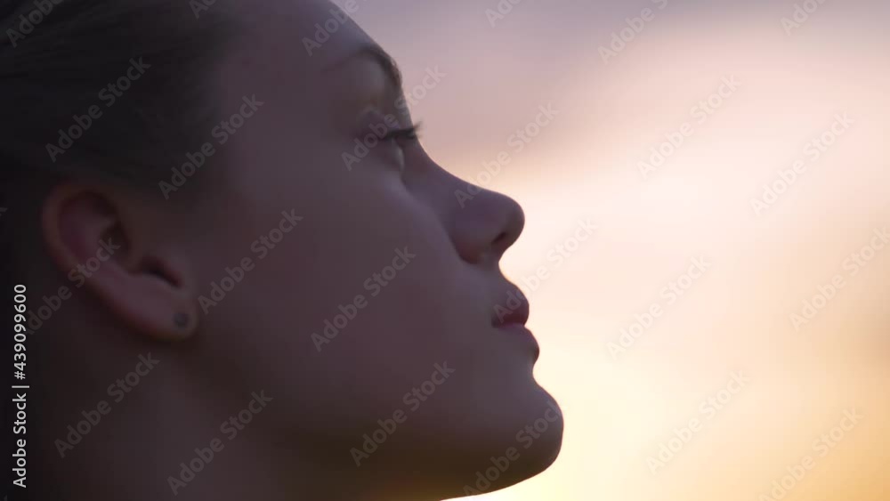 Portrait of a happy young teenager girl on the street. The girl dreams with pleasure with her eyes closed. The lady feels free, successful, ready to start the day, move forward. Portrait of a happy young teenager girl on the street. The girl dreams with pleasure with her eyes closed. The lady feels free, successful, ready to start the day, move forward.
