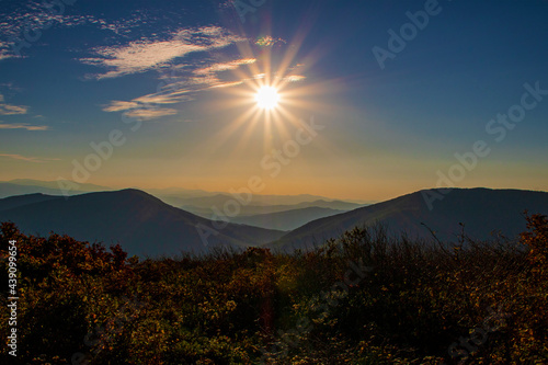 Glowing sun setting over the Blue Ridge Mountains