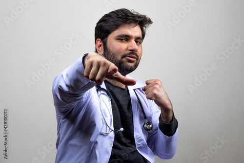 A doctor with joyful gesture pointing and punching forward