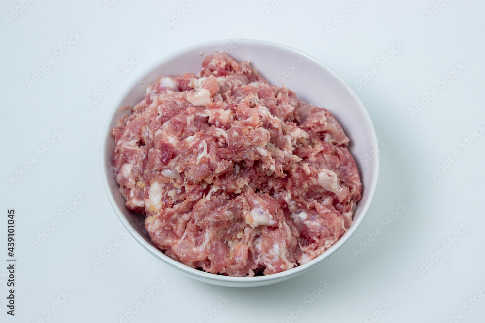 Fresh minced meat on a white plate. Minced pork meat. Fresh minced meat on a white plate. Minced pork meat.