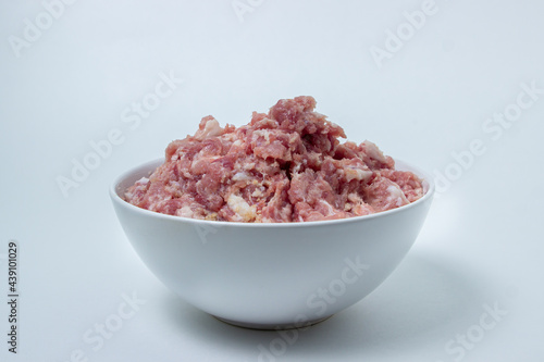 Fresh minced meat on a white plate. Minced pork meat.
