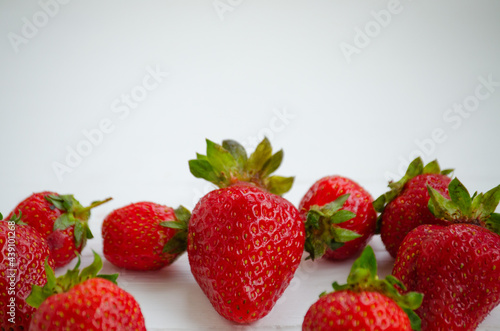 Ripe beautiful red strawberries on a white background.