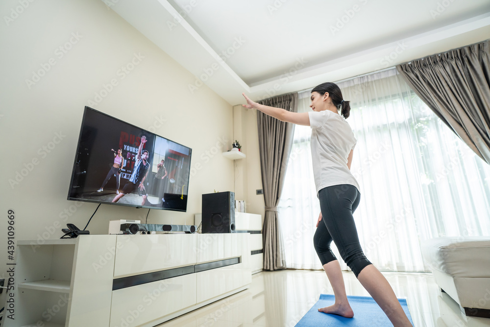 Asian beautiful girl exercise by learning online from video tutorial. Asian beautiful girl exercise by learning online from video tutorial.