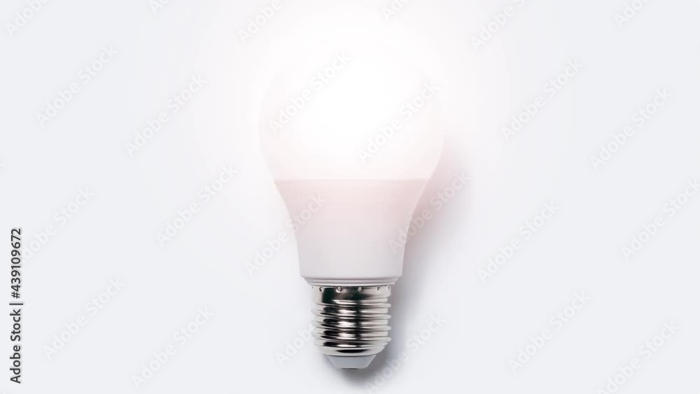 Stop motion animation photography concept. Close-up of light bulb glowing on white background. Stop motion animation photography concept. Close-up of light bulb glowing on white background.