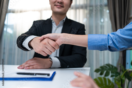 Banker man handshake with investor girl after sign contract agreement 