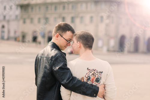 Gay couple walking in city centre, lifestyle © Ivan Zelenin