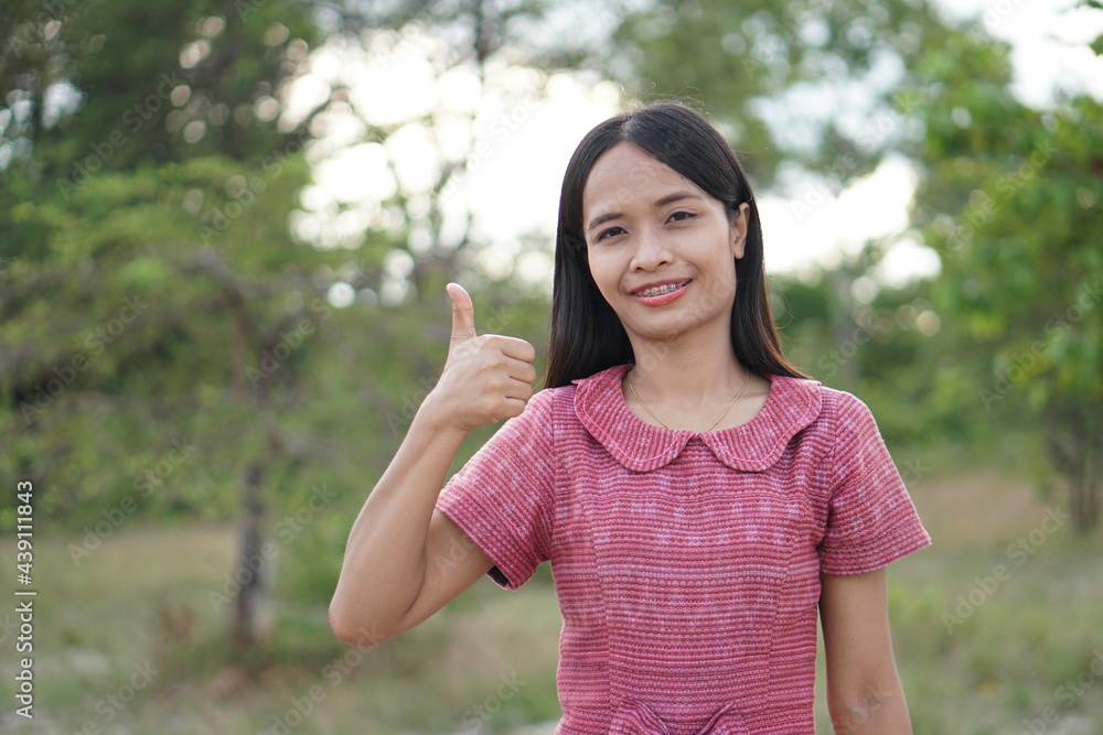 Asian woman smiling happily raise your hand to the sky nature background Asian woman smiling happily raise your hand to the sky nature background