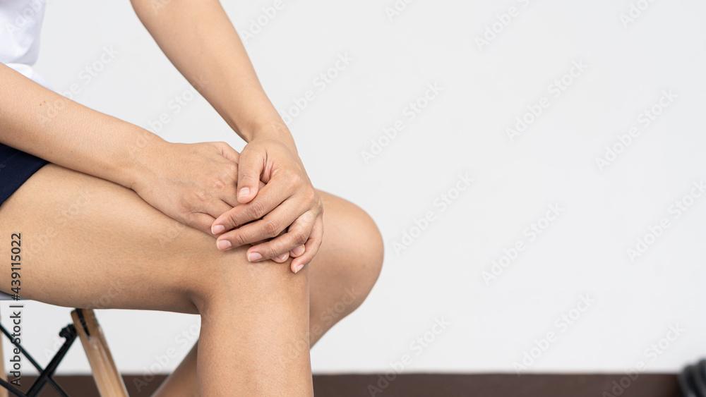 Woman with knee pain and suffering from health and medical concepts