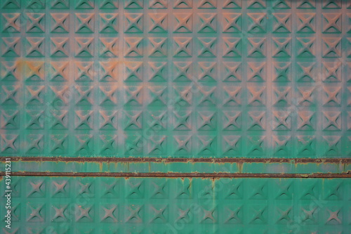 Abstract metal wall with crosses in iridescent colors and two rusty lines