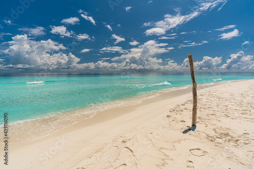 Paradise white sand beach and turquoise water in nice summer day, Gulhi Island, Maldives photo