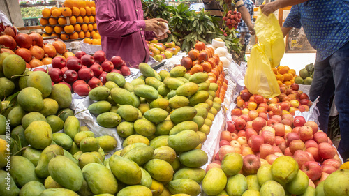 Customer using polybag to take fruits after buying from local fruit market at Mirpur, Dhaka, Bangladesh