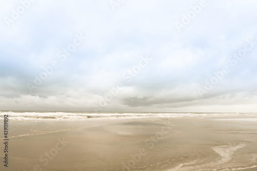 Vintage and retro toning of tropical beach with blue sky and clear sea which including of a wooden umbrella and chair in sunrise time with vintage retro tone. Vacation time as concept.	 photo