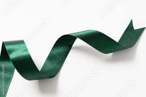 A roll green ribbon isolated on white
