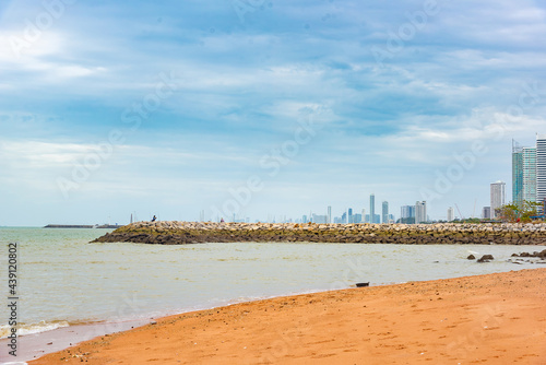 Vintage and retro toning of tropical beach with blue sky and clear sea which including of a wooden umbrella and chair in sunrise time with vintage retro tone. Vacation time as concept.	 photo