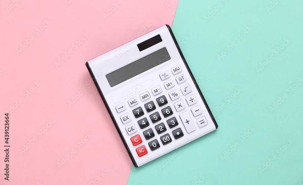 White calculator on pink blue pastel background. Top view. Flat lay White calculator on pink blue pastel background. Top view. Flat lay