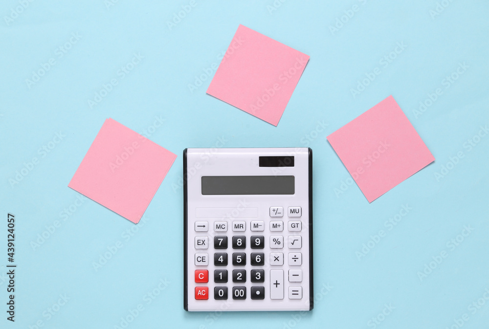 Calculator with blank memo papers on blue background Calculator with blank memo papers on blue background