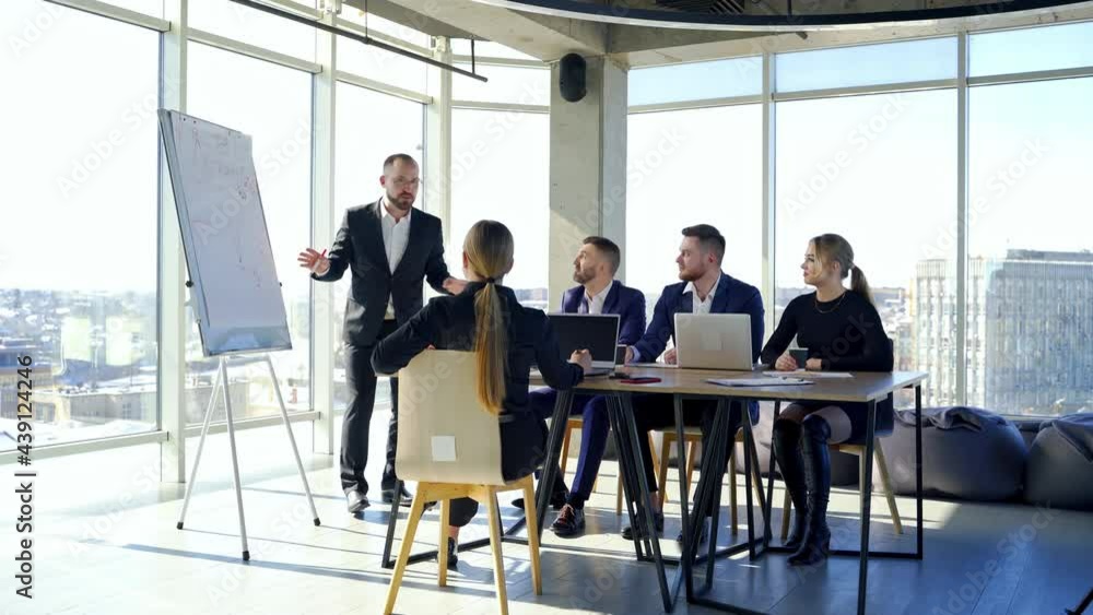 Colleagues employees working in office. Business partners cooperating together at a table. Team of business people meeting in modern office room. Colleagues employees working in office. Business partners cooperating together at a table. Team of business people meeting in modern office room.