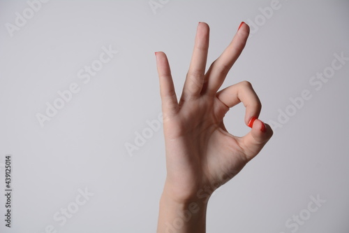 Woman's hand ok sign on white background.