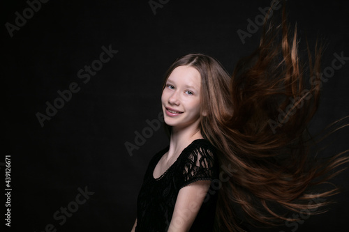 Portrait of a beautiful teenage girl with fluttering strands of hair.
