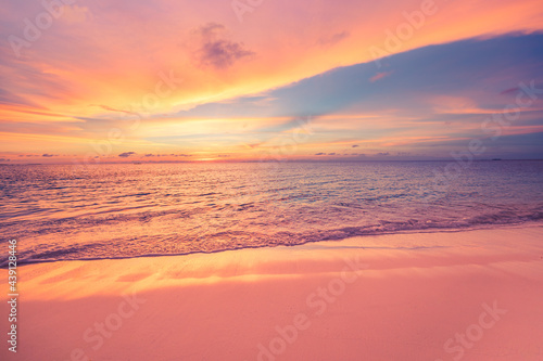 Closeup sea sand beach. Panoramic beach landscape. Inspire tropical beach seascape horizon. Orange and golden sunset sky calmness tranquil relaxing sunlight summer mood. Vacation travel holiday banner © icemanphotos