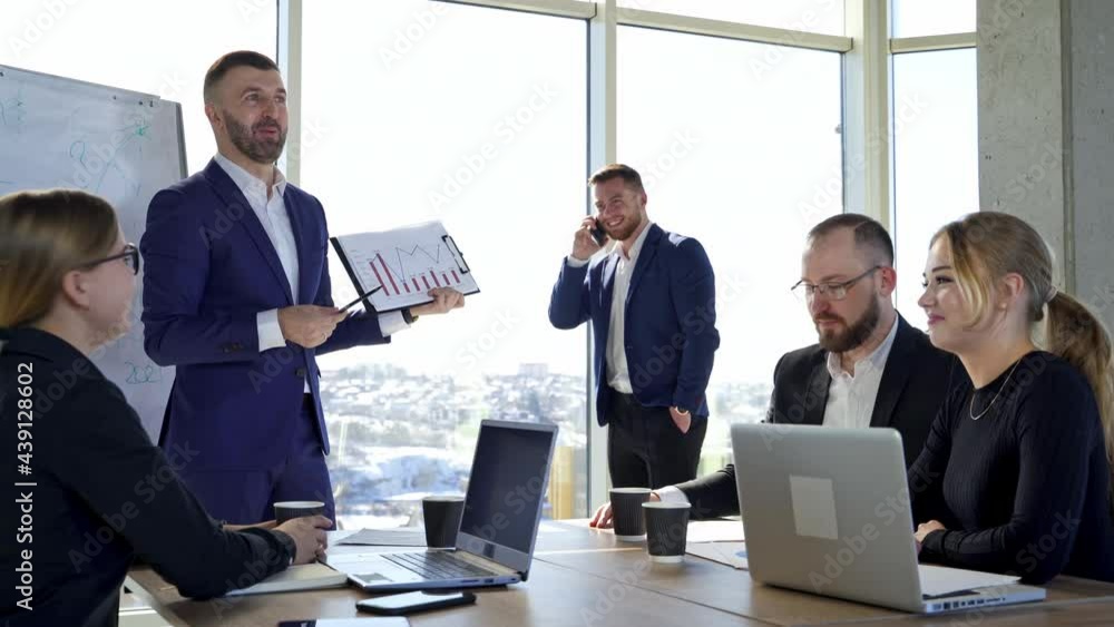 Positive business people in office. Team of entrepreneurs collaborating together. Man leader explaining business strategy to his colleagues. Positive business people in office. Team of entrepreneurs collaborating together. Man leader explaining business strategy to his colleagues.