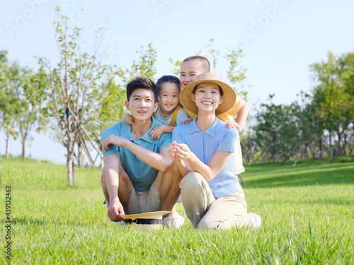 Happy family of four in the outdoor group photo