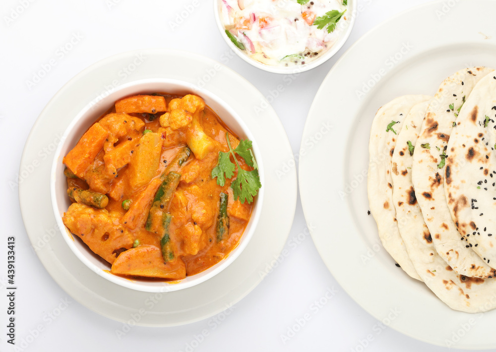 Dinner preparation of various indian food menus Mixed veg curry naan or roti chapati or Indian Flat bread Dinner preparation of various indian food menus Mixed veg curry naan or roti chapati or Indian Flat bread