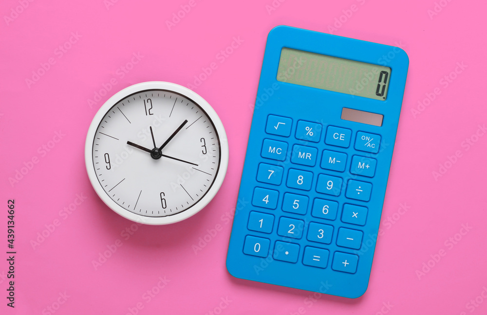 White clock and calculator on pink background. Minimalistic studio shot. Top view White clock and calculator on pink background. Minimalistic studio shot. Top view