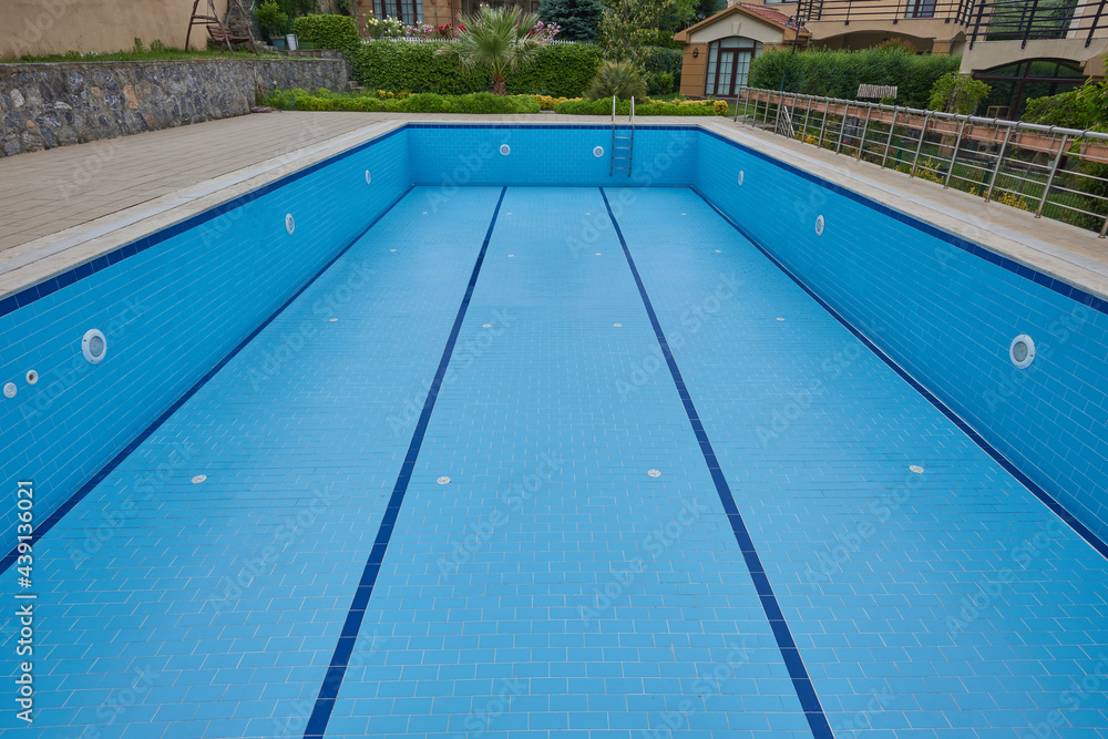 Empty pool in the site, blue ceramic outdoor style.