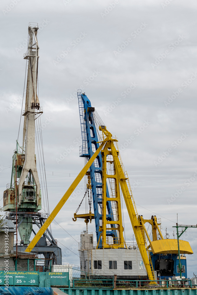 Large cranes in the river port. Outdoors, day light Front view