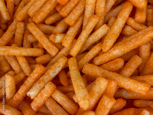 Abstract background of spicy snacks in the shape of long squares