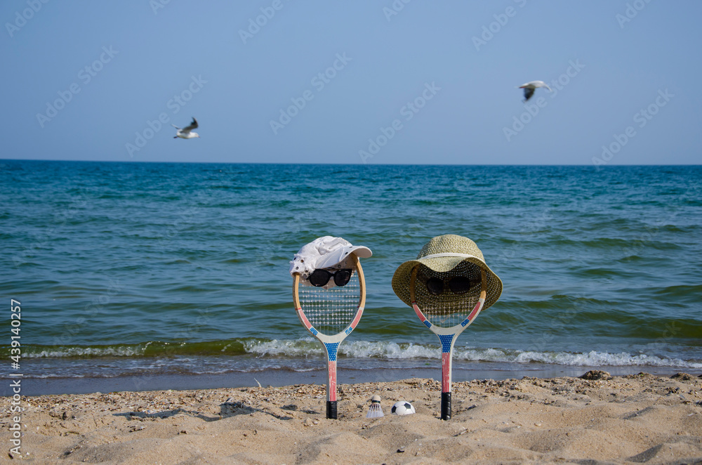 Badminton rackets in the sand of the beach Badminton rackets in the sand of the beach