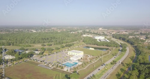 Hyperlapse of Drone Flying over Suburbs and Descending into Golf Course photo