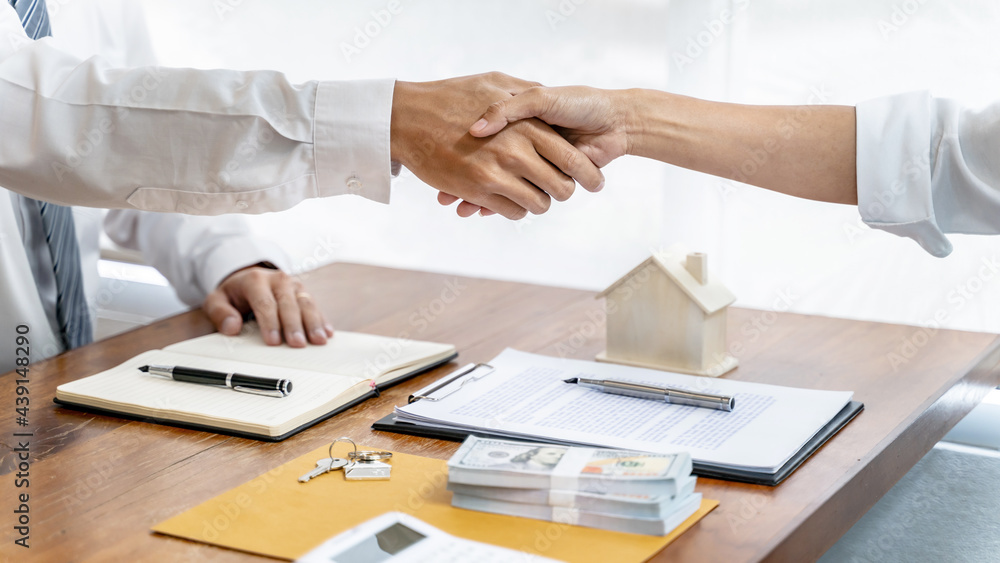 home loan insurance. .Real estate broker and client sign contract insurance agreement document. Business meeting concept home loan insurance. .Real estate broker and client sign contract insurance agreement document. Business meeting concept