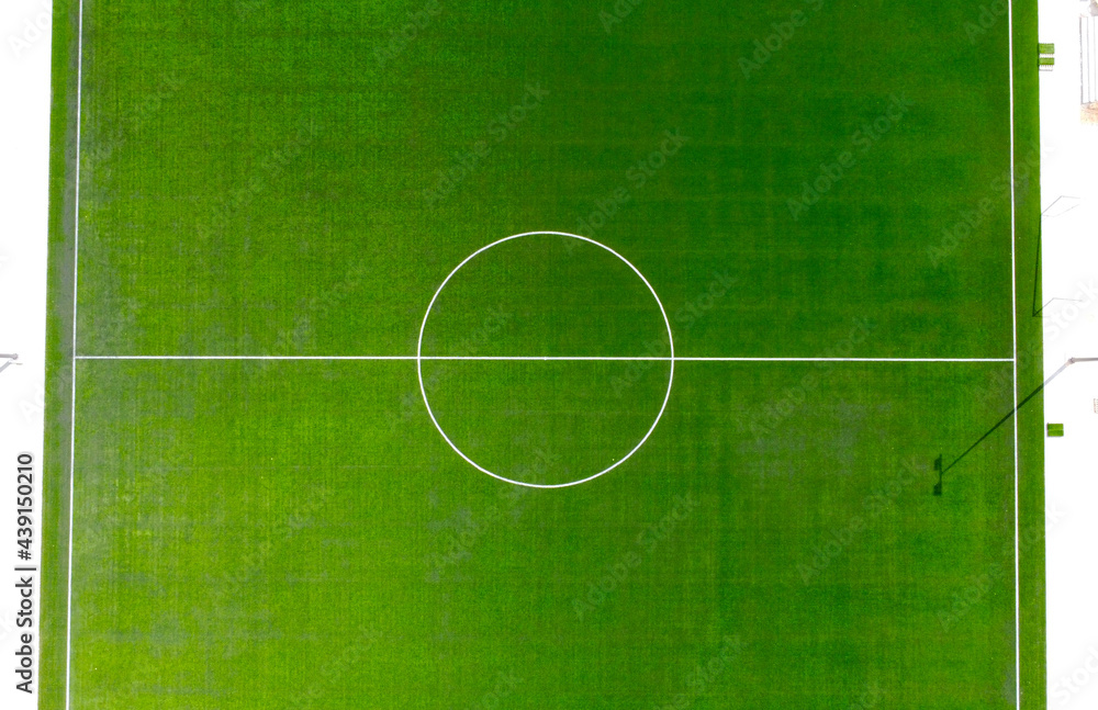 Aerial view of a green soccer field with white paint markings Aerial view of a green soccer field with white paint markings