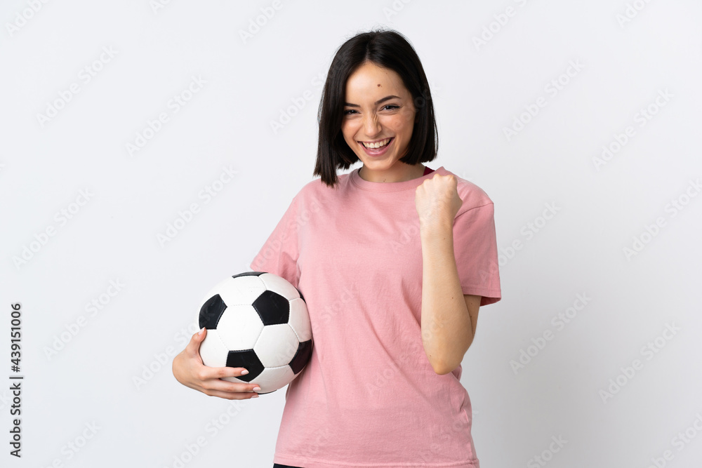 Young caucasian woman isolated on white background with soccer ball celebrating a victory