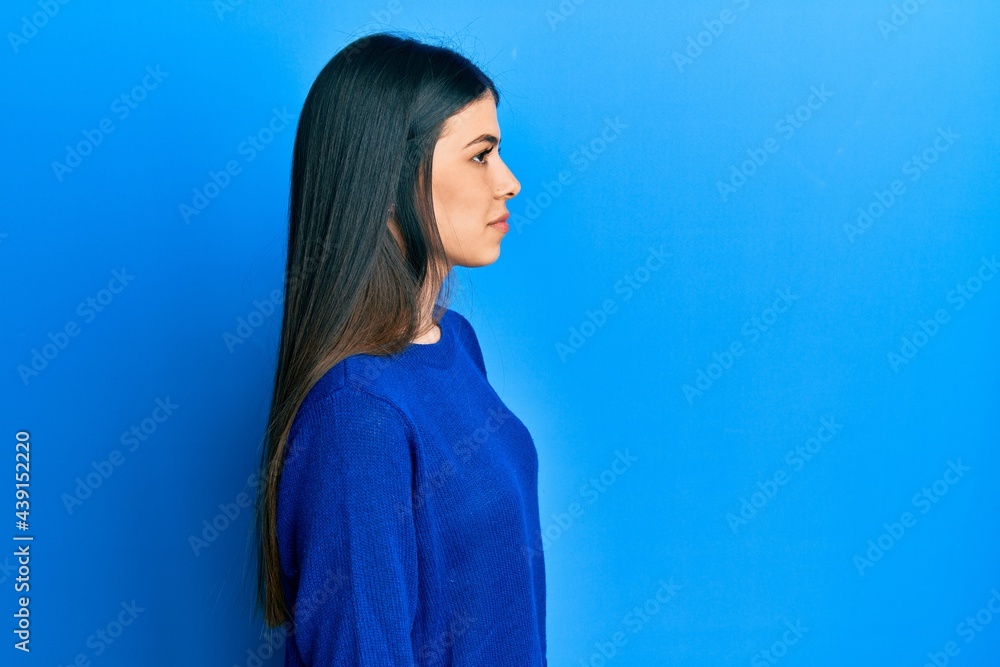 Young hispanic woman wearing casual clothes looking to side, relax profile pose with natural face with confident smile. Young hispanic woman wearing casual clothes looking to side, relax profile pose with natural face with confident smile.