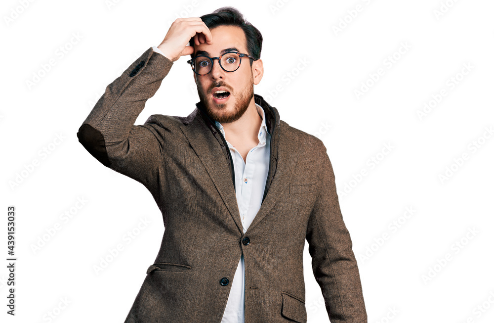 Young hispanic man wearing business jacket and glasses surprised with hand on head for mistake, remember error. forgot, bad memory concept. Young hispanic man wearing business jacket and glasses surprised with hand on head for mistake, remember error. forgot, bad memory concept.