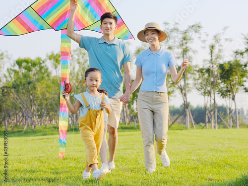 Happy family of three flying kites in the park © eastfenceimage