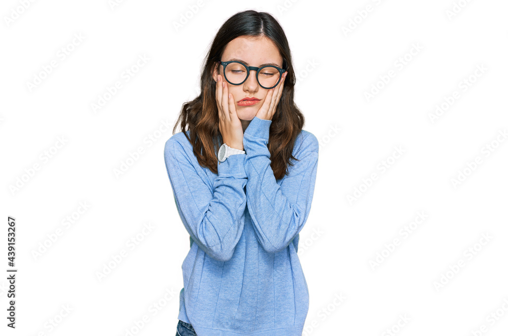 Young beautiful woman wearing casual clothes and glasses tired hands covering face, depression and sadness, upset and irritated for problem