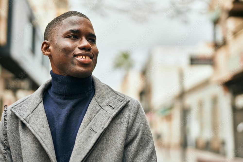Young african american man smiling happy standing at the city Young african american man smiling happy standing at the city