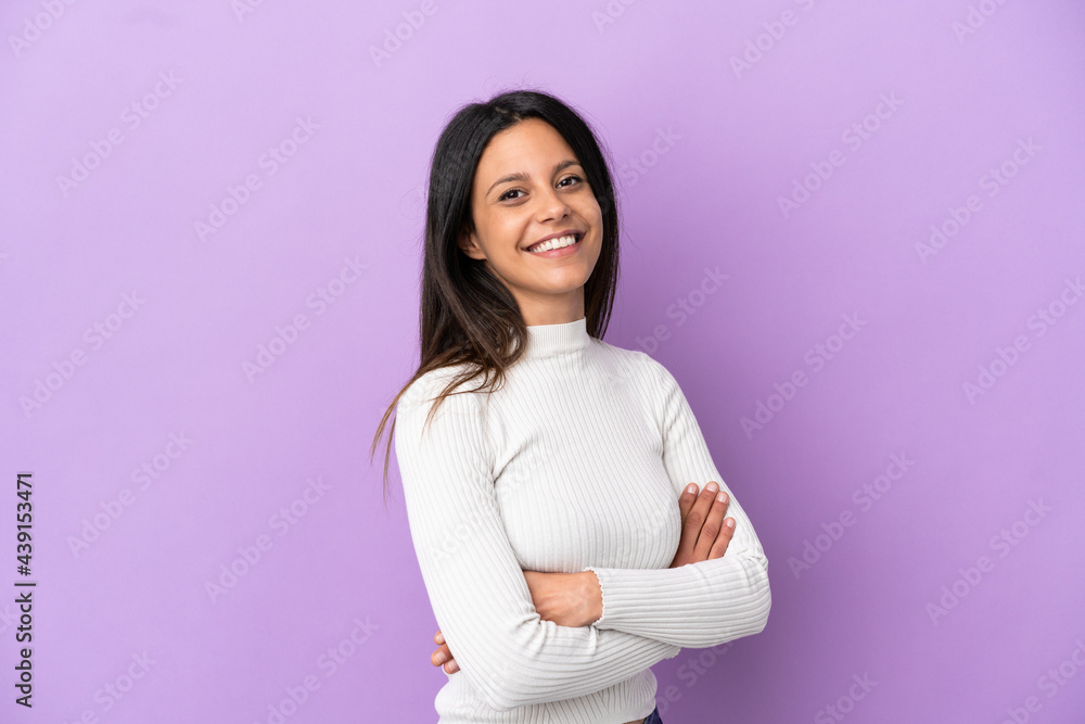 Young caucasian woman isolated on purple background with arms crossed and looking forward Young caucasian woman isolated on purple background with arms crossed and looking forward