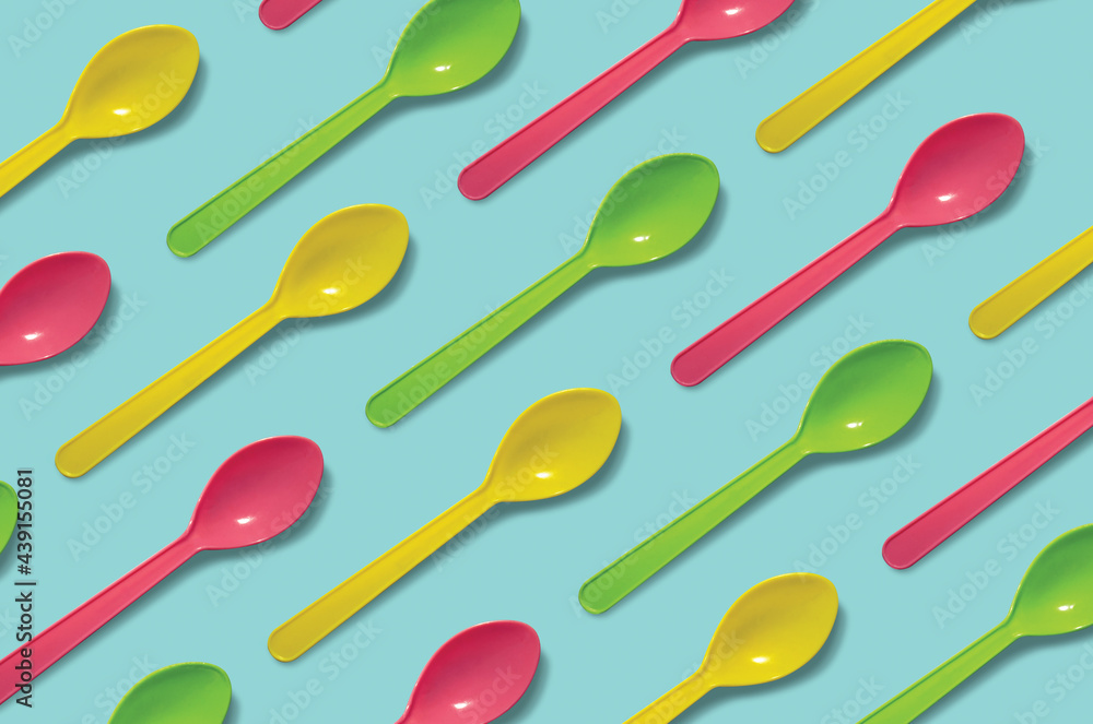 Plastic spoons pattern on light blue background. Plastic spoons pattern on light blue background.