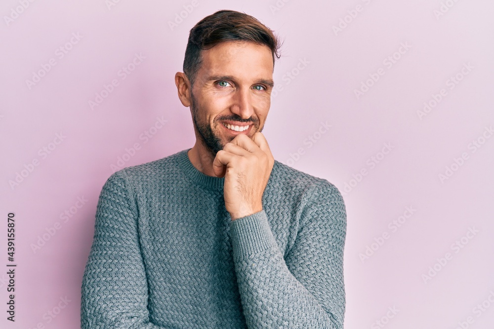 Handsome man with beard wearing casual winter sweater smiling looking confident at the camera with crossed arms and hand on chin. thinking positive. Handsome man with beard wearing casual winter sweater smiling looking confident at the camera with crossed arms and hand on chin. thinking positive.